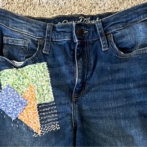 Universal Thread Hand embroidered patched jeans with unique sashiko stitching.